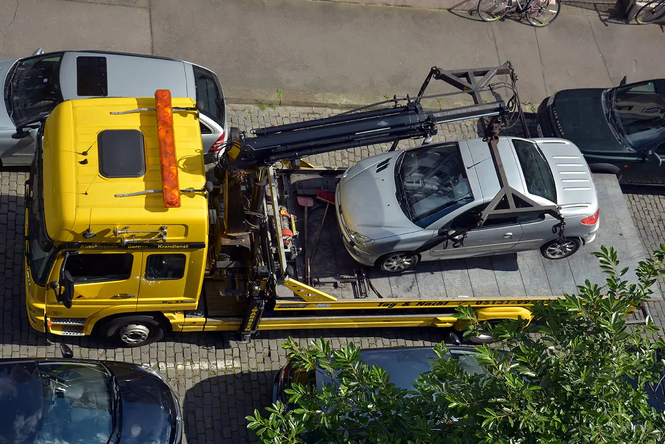 Fahrzeug im Halteverbot wird auf Abschleppwagen gehievt